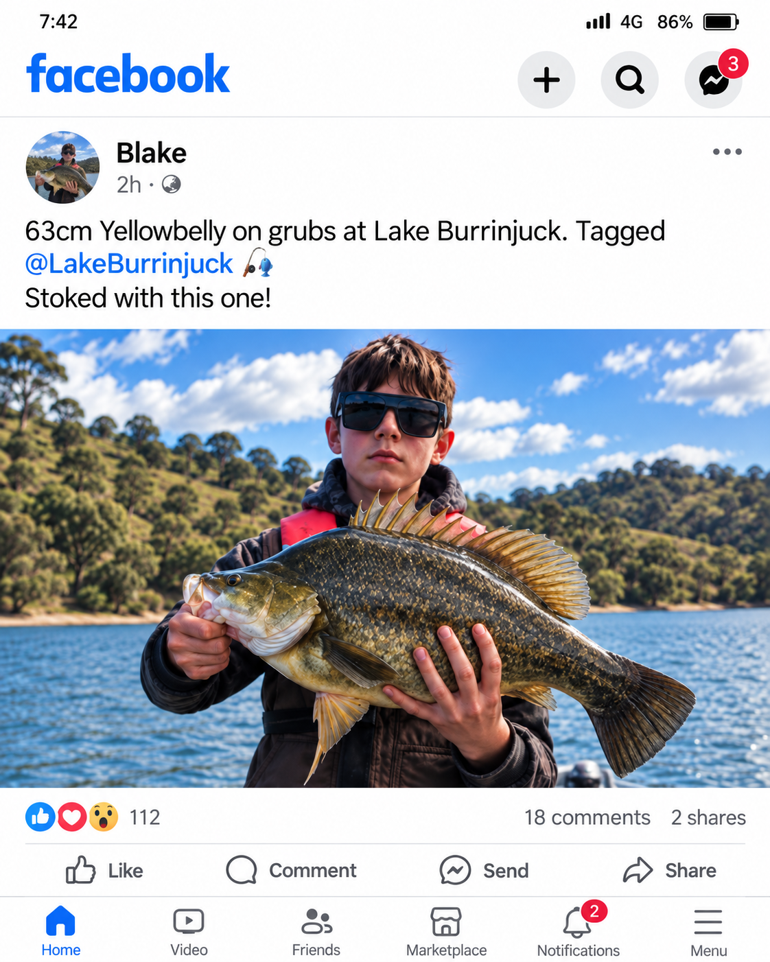 Blake holding his catch beside Lake Burrinjuck