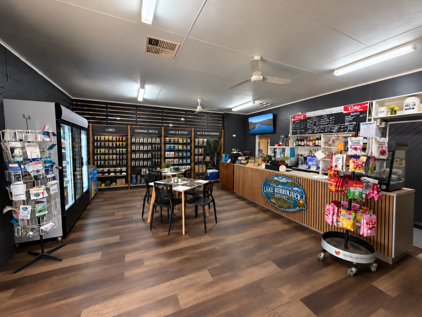 Shop interior with a timber counter, refreshments, seating and fishing tackle displays