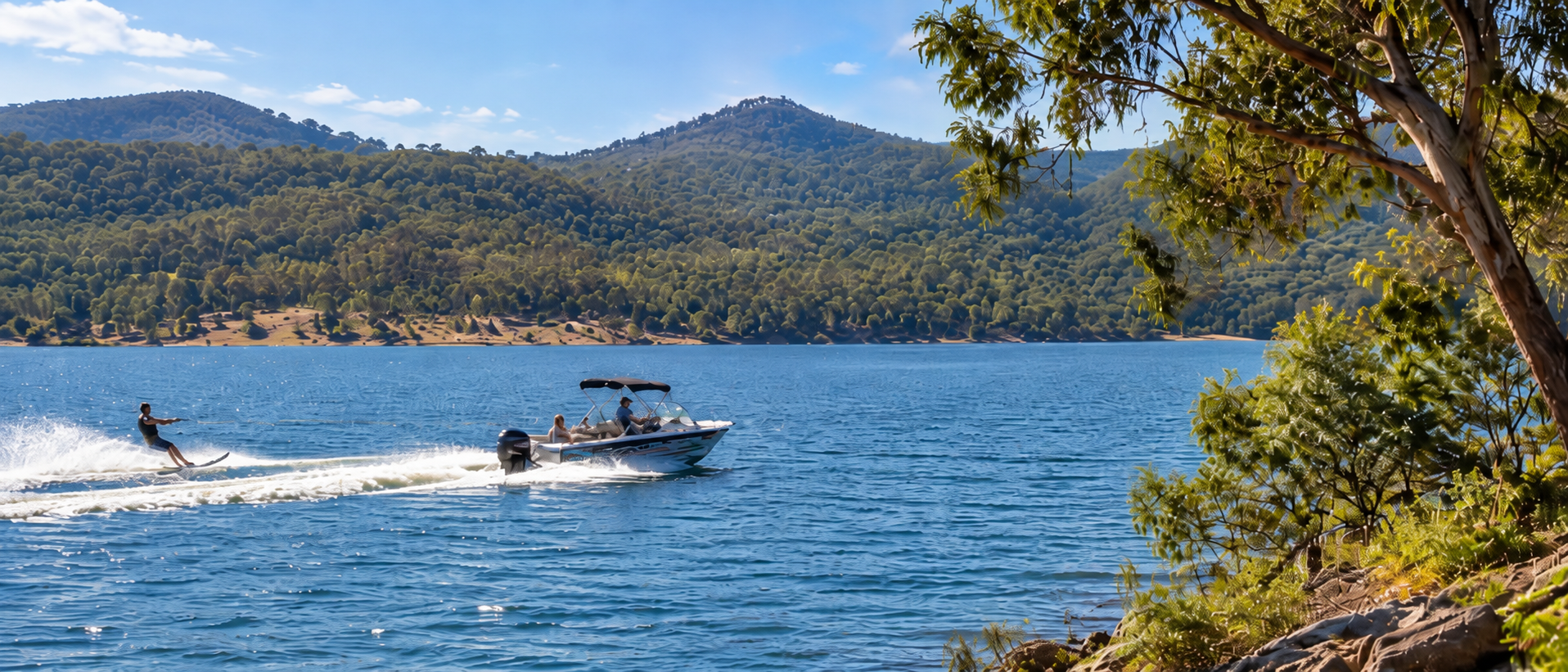 Waterskier behind a boat on the lake during the day